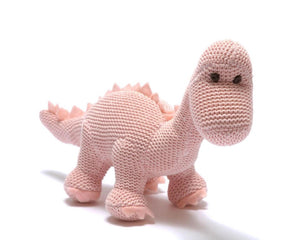 The DARK PINK KNITTED DIPLODOCUS TOY from BEST YEARS LTD stands against a white background. This soft, plush dinosaur features a long neck, small brown eyes, and short, stubby spikes along its back and tail. Its cozy texture makes it perfect for hugging—a delightful addition to newborn gifts.