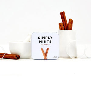 A metal tin labeled "Simply Gum - Cinnamon Mints" by Simply Gum features two cinnamon sticks illustrated below the text, hinting at a delightful fall flavor. These cinnamon mints have a net weight of 1.1 oz (30 g).