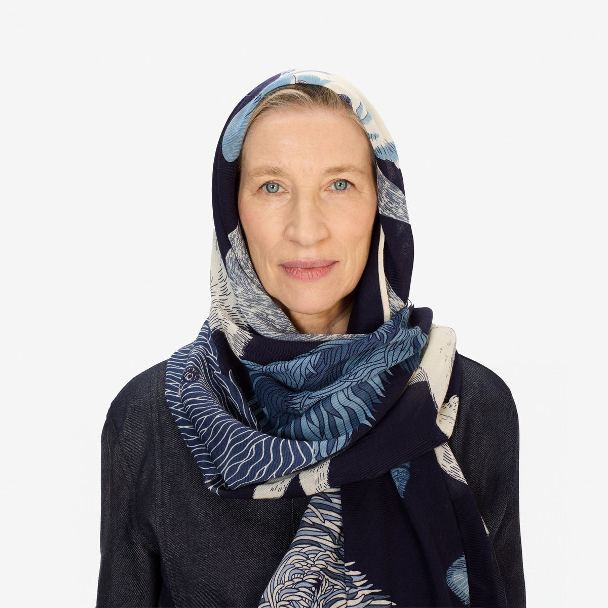 The INOUI EDITIONS TOUTOU DOGS WOOL SCARF IN NAVY features stylized blue and white dogs with fluffy, textured fur, arranged closely in a vertical frame, inspired by the brand INOUI&#39;s signature design.