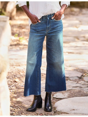 The FRANK & EILEEN Galway Wide Leg Jean in 1999 Wash features a faded ombre effect, cropped raw hem with unfinished edge, classic five-pocket styling, and visible stitching for an effortlessly cool look.