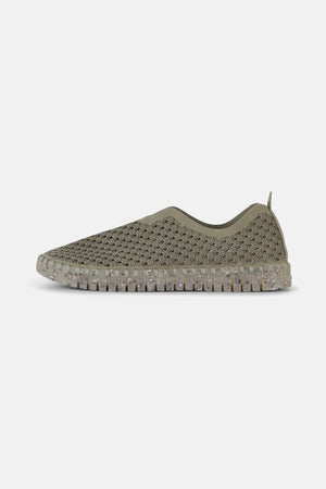 A pair of olive green ILSE JACOBSEN - THE TULIP SHOE from LINES OF DENMARK, featuring a perforated, breathable upper design made from recycled microfiber and a speckled, translucent natural rubber sole. The shoes are displayed at a three-quarter angle on a plain white background.