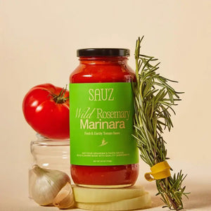 A 16-ounce (473g) jar of SAUZ - WILD ROSEMARY MARINARA tomato sauce. The green label with beige text describes it as "Fresh & Earthy Tomato Sauce" and "Not-Your-Grandma's Pasta Sauce." Ideal for a homemade dinner, the clear glass jar elegantly displays the sauce.