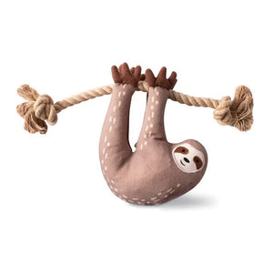 The FRINGE STUDIO - EAT SLEEP REPEAT SLOTH DOG TOY from PET SHOP BY FRINGE STUDIO hangs by its limbs from an eco-friendly jute rope and is crafted with non-toxic cotton canvas. It includes a recycled water bottle fill, crazy crinkle paper inside, and super loud squeaker balls. Various features are listed around the toy in small icons.