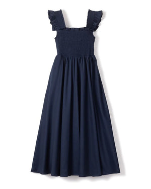 A sleeveless, navy blue Petite Plume - Twill Margaux Smocking Night Dress with a smocked bodice and ruffled straps. The long, flowing skirt creates an elegant silhouette suitable for casual or formal occasions, evoking the timeless charm of the French Riviera.