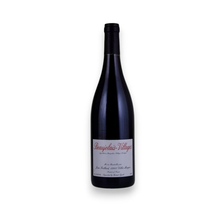 A dark glass wine bottle with a black cap and a white label reading &quot;JEAN FOILLARD BEAUJOLAIS-VILLAGES 2023&quot; by WINE: TRYON stands against a plain white background, capturing the classic Burgundy Gamay expression.