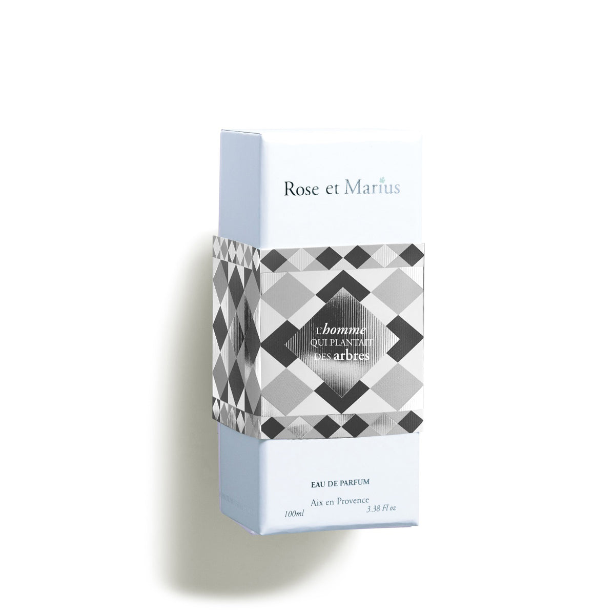 A light blue rectangular box labeled &quot;ROSE ET MARIUS - THE MAN WHO PLANTED TREES EAU DE PARFUM 100ML&quot; features geometric black, white, and gray patterns and hints at a woody fragrance. &quot;Eau de Parfum&quot; and &quot;100 ml&quot; appear at the bottom.