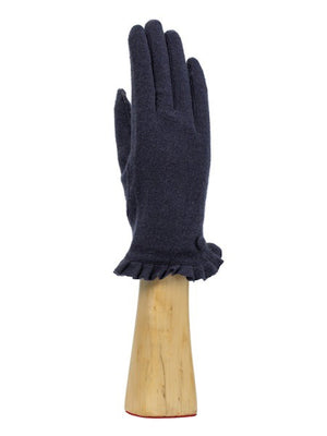 A green, wool knit glove from Santacana Madrid World Glove Company is showcased upright on a wooden hand-shaped stand, featuring a simple pleated trim around the wrist.