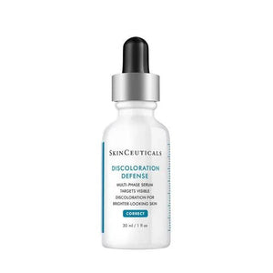 A 30 ml bottle of SKINCEUTICALS - DISCOLORATION DEFENSE serum from SKIN CEUTICALS, featuring a white design with a black dropper cap. The label highlights it as a multi-phase serum that targets visible skin discoloration and serves as a dark spot corrector for achieving brighter-looking skin.