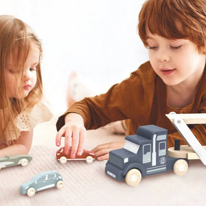 The SPEEDY MONKEY - CAR TRANSPORTER, by the brand SPEEDY MONKEY, is a charming wooden truck with a detachable trailer that elegantly carries four vibrant cars in blue, green, red, and orange. Primarily showcasing colors of blue and beige, this simple design inspires imaginative play for young minds.