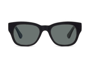 A pair of CADDIS - MIKLOS SUNGLASSES in matte black, featuring a premium bio-based acetate frame and grey polarized lenses, positioned at an angle to showcase the inside arm with the visible CADDIS brand name.