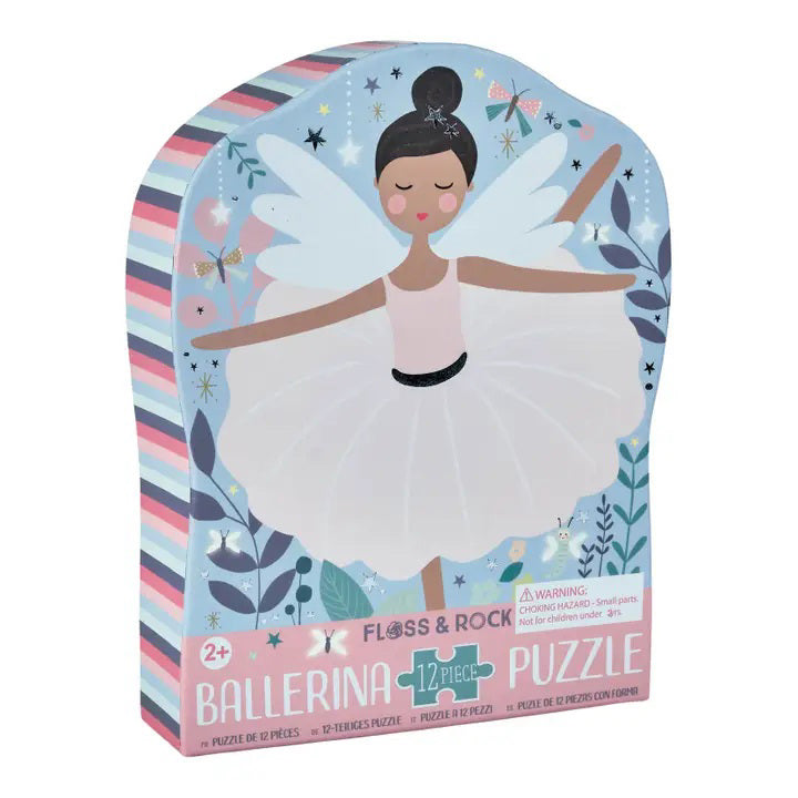 The FLOSS &amp; ROCK Enchanted Ballerina Jigsaw Puzzle features a ballerina in a pink tutu with wings, surrounded by whimsical elements like swans, flowers, and dragonflies. Her shiny foiled costume and the starry tree background create a dreamy fairy-tale atmosphere.