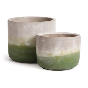 Two Ashland Cylinder Pots from Napa Home and Garden feature a gradient design, transitioning from light natural top to earthy green base. The larger pot is slightly behind the smaller one, both with a smooth matte finish for a perfect weathered look in your garden.