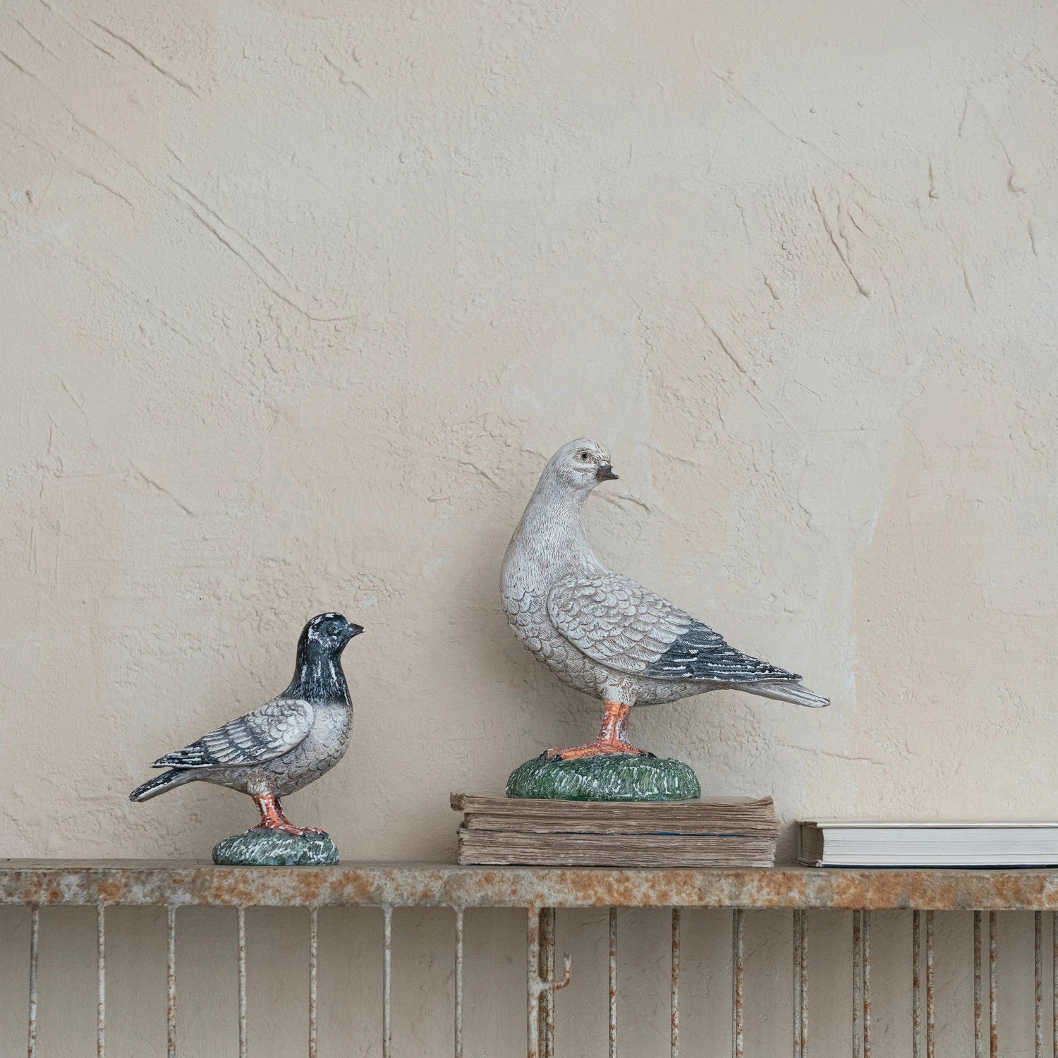 A detailed VINTAGE REPRODUCTION PIDGEON from CREATIVE COOP with textured gray feathers and dark gray wings stands on a green, grassy base. The lifelike pigeon figurine has an expressive face and intricate feather detailing, perfect for vintage-themed decor.