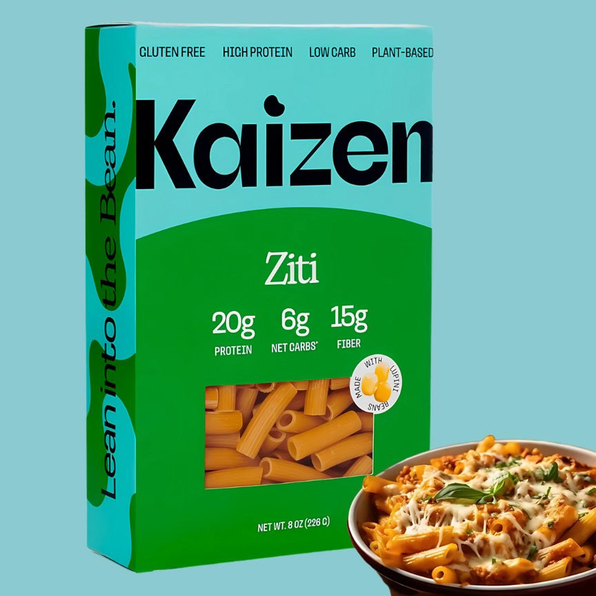 A box of KAIZEN brand Ziti pasta. The turquoise and green box, adorned with "KAIZEN FOOD COMPANY" in bold black letters and "Ziti" in white, highlights attributes like "Gluten-Free," "High-Protein," "Low-Carb," and "Plant-Based." Inside is the gluten-free pasta, clearly visible through the packaging.