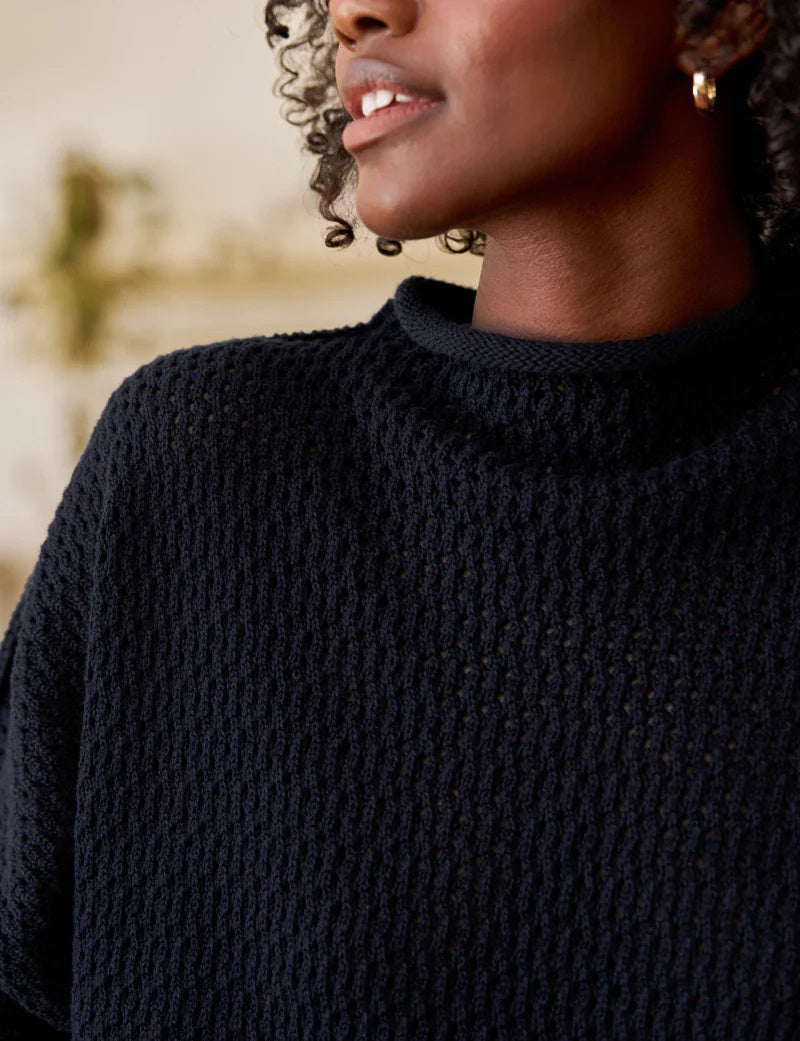 The FRANK &amp; EILEEN MONTEREY Pointelle Rolled Funnel Neck Sweater in Marine features a loose, textured Italian pointelle knit, long sleeves, high rolled neckline, and is crafted from 100% cotton. Shown laid flat on a white background.