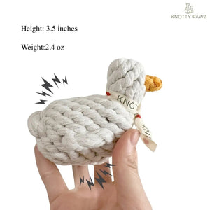 The KNOTTY PAWZ Agnes White Duck Squeaky Rope Toy features a knitted design with a white body, orange beak, and ribbon embellishment. Set on light gray fabric, this toy appeals to eco-conscious pet owners who prefer handmade products.