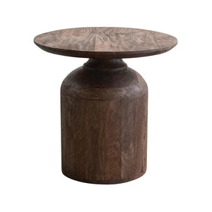 The MANGO SIDE TABLE by CREATIVE COOP is a circular piece made from mango wood, featuring a natural, dark walnut finish with visible wood grain patterns. The surface is smooth and rich in color, showcasing the organic textures and swirls of the wood against a plain white background.