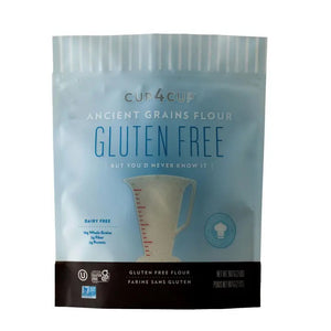 A blue and white package of CUP4CUP's gluten-free ANCIENT GRAINS FLOUR. The front text indicates it is dairy-free and highlights 16g of whole grains per serving. The bottom section lists certification icons and a weight of 500g/2lbs.