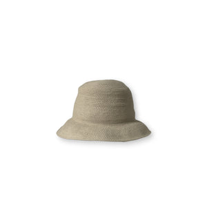 The BEACH HARE - WANDER HAT, a light-colored, wide-brimmed straw hat handmade by BEACH HARE in NYC, is showcased on a white background. It features a slightly curved brim and a simple woven pattern that exudes a casual and summery look. Additionally, it's packable for easy travel.