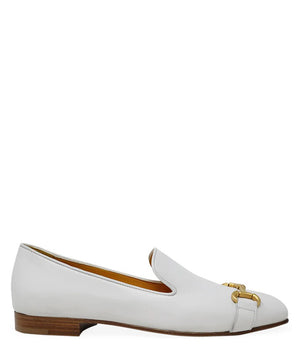 The Madison Maison Square Toe Loafer in gold metallic showcases its handmade craftsmanship and 100% leather composition. This single loafer, characterized by a low wooden heel and square toe, is adorned with a decorative gold buckle on the front. The opulent gold interior lining enhances its luxurious appeal, elegantly displayed in a side profile view against a plain white background.