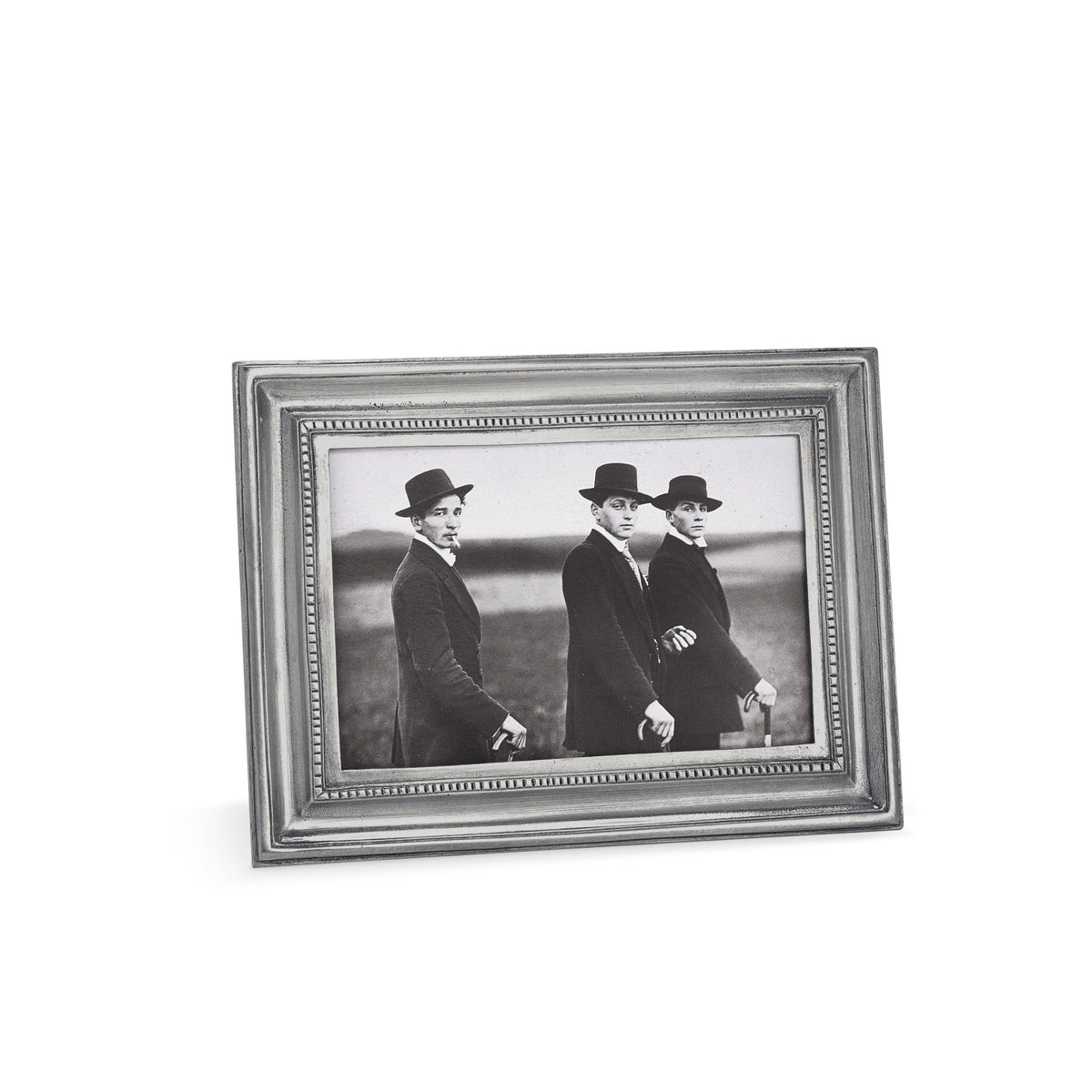 The MATCH - TOSCANA RECTANGULAR PEWTER PHOTO FRAME MEDIUM by MATCH displays a black-and-white photo of three people in suits and hats outdoors, looking at the camera, with a slightly angled shot and blurred background.