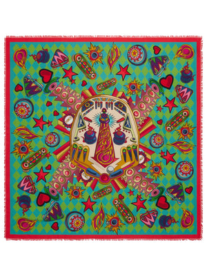 The FRANCO FERRARI DILETTO COTTON SILK SCARF 135CM is a colorful square scarf that features a symmetrical design with vibrant patterns. The central motif includes rockets and futuristic elements on a green and yellow diamond-patterned background. Surrounding it are hearts, stars, and flames in bold reds, blues, and yellows. Crafted in Italy from luxurious silk and cotton blend, the edges are fringed for an added touch of elegance.
