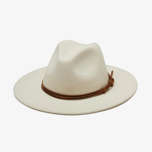 The BILLIE FEDORA HAT by WYETH is a tan wool felt fedora with a leather trim, showcasing a pinched crown and mid brim, beautifully displayed against a plain white background.