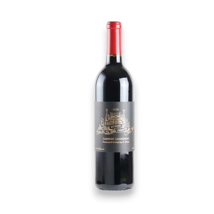 A bottle of RAILSBACK FRERES &#39;Roman Ceremony&#39; Cabernet Sauvignon 2021 from WINE: TRYON, with a gold chateau illustration on the label and red foil top, is displayed against a white background. Shipping available in North Carolina.
