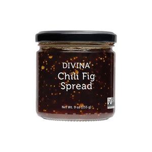 A jar of DIVINA - CHILI & FIG SPREAD from GOURMET FOOD SOLUTIONS features a black lid and a transparent body, showcasing the dark, chunky, sweet and spicy spread inside. The label on the front reads “DIVINA - CHILI & FIG SPREAD” and indicates a net weight of 9 oz (255 g). Ideal for pairing with cheese, it is certified Non-GMO Project Verified.