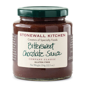 A jar of STONEWALL KITCHEN- BITTERSWEET CHOC SAUCE, featuring a green lid and a white label with green and brown text, labeled gluten-free with a net weight of 354 grams (12.5 oz). A classic from STONEWALL KITCHEN, renowned for its rich chocolate flavor, making it ideal as a hot fudge sauce.