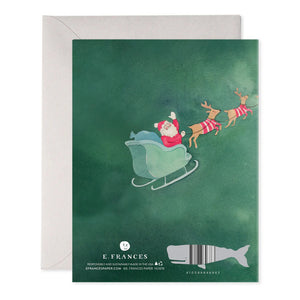 The TO ALL A GOOD NIGHT HOLIDAY CARD from E.FRANCES PAPER features a delightful Santa illustration in a sleigh pulled by reindeer, set against a green background. The partially visible white envelope adds an extra touch of charm. At the bottom, you'll find the logo, contact information, barcode, and a whimsical whale illustration.