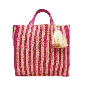 The MAR Y SOL - AMALFI TOTE BAG by MAR Y SOL is a yellow and white striped woven bag with two short handles and a large beige tassel near the top. It features a rectangular shape and textured fabric, offering a chic silhouette that exudes a handcrafted look.