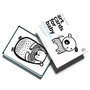 A set of WEE GALLERY - PET ART CARDS is displayed. The open box reveals a high-contrast, black-and-white illustration of a bear-like animal to stimulate visual perception. The box lid, partially open, has "art cards for baby" and an illustration of a panda on the cover.