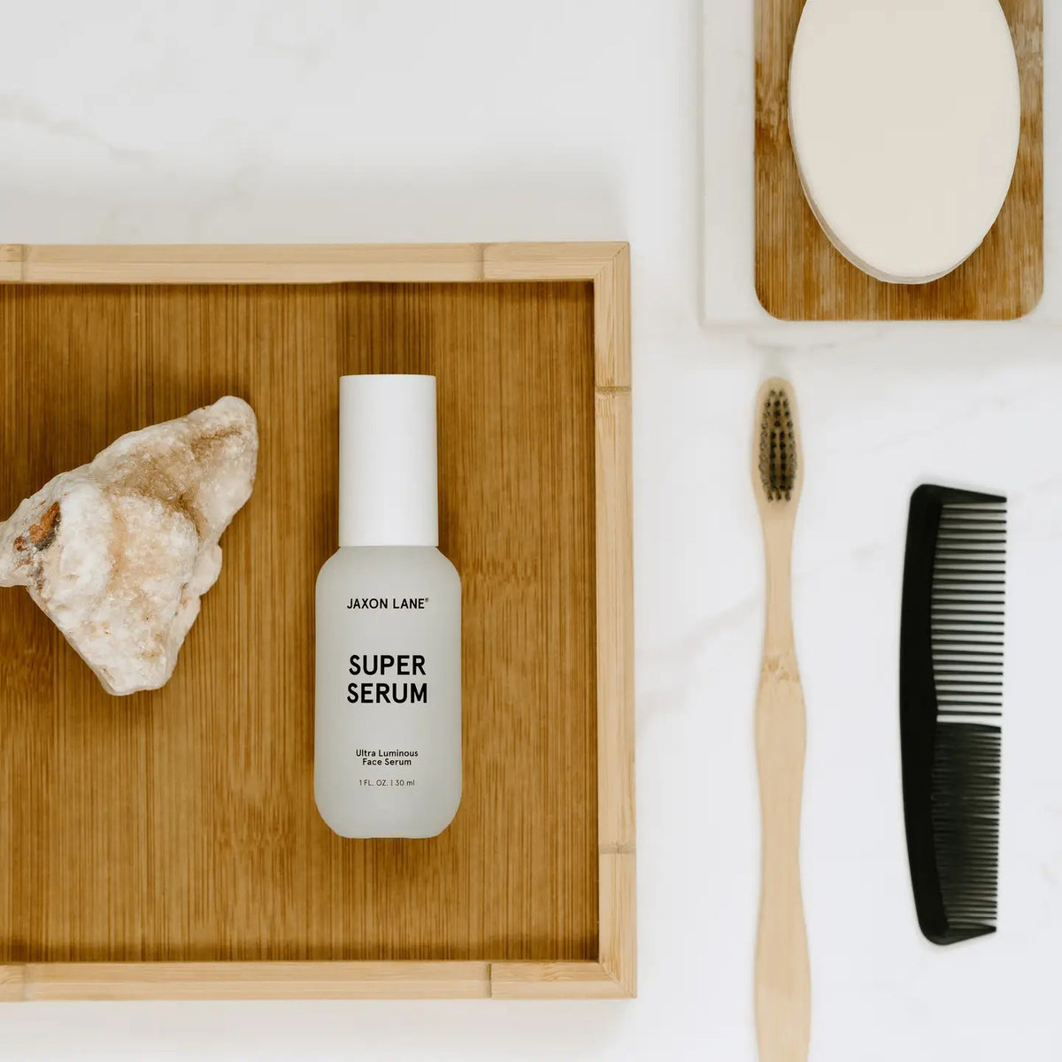A white bottle labeled &quot;JAXON LANE - SUPER SERUM ULTRA LUMINOUS FACE SERUM FOR MEN,&quot; 1 fl oz / 30 ml, with a white cap stands upright on a plain white background—ideal for men seeking a brightening serum with niacinamide.