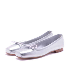 The MICHELE LOPRIORE - PALOMA ballet flat with a square toe, crafted from genuine silver leather, features a delicate bow on the front and a low-profile brown sole. Made in Italy, this elegant shoe is set against a plain white textured background.