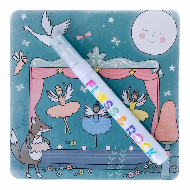 A colorful, fairy-tale-themed illustration shows a stage with dancing ballerina fairies, a smiling moon, and a fox in a dress. A white pen labeled &quot;FLOSS &amp; ROCK&quot; lies diagonally across the image. This travel-friendly toy, known as the FLOSS AND ROCK - ENCHANTED WATER PENS AND CARDS, includes reusable water cards adorned with stars and whimsical designs.