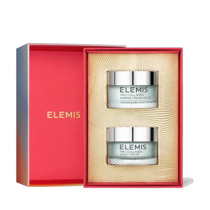 An image displays two skincare products from the Pro-Collagen line. The upper jar, "Elemis Pro-Collagen Marine Cream SPF 30," is elegantly placed above the lower jar, "Elemis Pro-Collagen Night Cream." Both jars are light blue with silver accents and are part of the "ELEMIS - THE PRO-COLLAGEN CLASSICS GIFT SET" by ELEMIS - STEINER, offering effective anti-aging benefits.