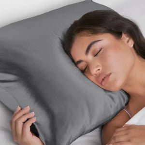 A satin pillowcase with a beige and white leopard print design is displayed against a plain background. To the right of the luxurious pillowcase is its packaging, which reads "SATIN PILLOWCASE" by KITSCH and highlights its 600-thread count and benefits for frizz-free hair and healthy skin.