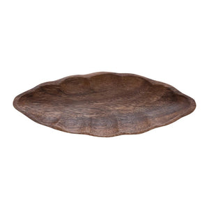 The ACACIA WOOD LEAF DISH by CREATIVE COOP is a leaf-shaped wooden tray with textured brown surface and wavy edges, made from exquisite acacia wood. Perfect for serving or decoration, this hand-carved piece adds nature's elegance to any setting.