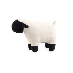 Introducing the LAMBWOLF COLLECTION - DOLLY SQUEAKER TOY by LAMBWOLF COLLECTIVE: a sweet, plush toy in the shape of a sheep, featuring a white body and black head and legs. This mama sheep boasts a minimalist design with simple, smooth lines and no facial features. Slightly textured with subtle, curved patterns, it’s as comforting as it is charming.