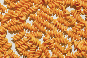 An image of a box of KAIZEN - FUSILLI pasta from KAIZEN FOOD COMPANY highlights its gluten-free, high protein, low carb, and plant-based attributes. The details on the box state: "19g Protein, 2g Net Carbs, 17g Fiber" per serving and feature the phrase "Lean into the Bean" on the side. Each box contains 8 oz (227g).