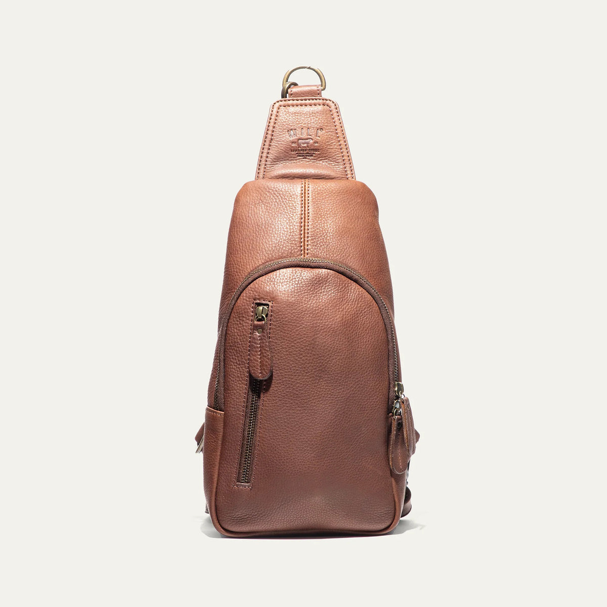 The WILL LEATHER GOODS - ZIP AROUND SLING BAG by WILL LEATHER GOODS is a brown full-grain leather sling bag with a zippered design, front zipper pocket, adjustable strap, and visible stitching, displayed upright on a white background.