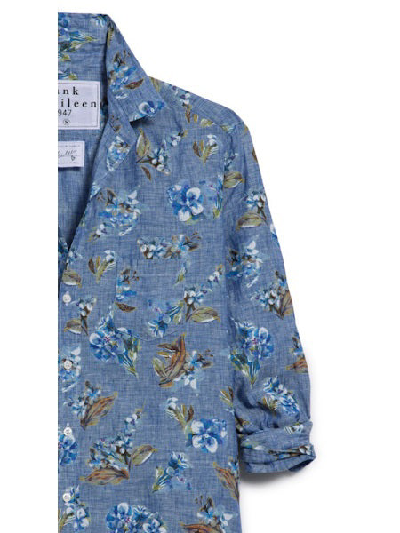 The FRANK &amp; EILEEN Finbar Men’s Button Up Shirt features a blue floral print in blue, white, and green Italian linen. This everyday shirt includes a collar, rolled-up sleeves, and an inner label detail.
