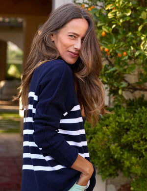 The FRANK & EILEEN Monterey rolled funnel neck sweater in Marine White Stripe boasts Italian cotton with a navy blue body and white horizontal stripes. When laid flat on a white background, its sleeves are slightly folded inward.