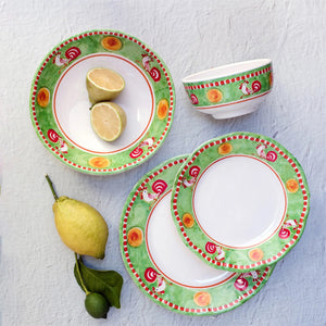 The VIETRI - MELAMINE CAMPAGNA DINNER PLATE by VIETRI features a decorative border with blue and white birds, red tulips, and green leaves on a vibrant orange background. The central section of the plate is plain white, and the border also includes a blue rim, ensuring durability while adding charm to your table.