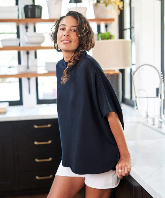 The FRANK &amp; EILEEN Audrey Funnel Neck Capelet in British Royal Navy is a simple, loose-fitting dark navy blue t-shirt. Made from 100% cotton fleece, it features a high neckline and short sleeves with a boxy, relaxed silhouette against a white background.