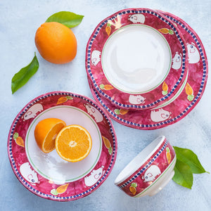 The VIETRI - MELAMINE CAMPAGNA DINNER PLATE by VIETRI features a decorative border with blue and white birds, red tulips, and green leaves on a vibrant orange background. The central section of the plate is plain white, and the border also includes a blue rim, ensuring durability while adding charm to your table.