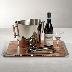 The BRASSERIE STEEL & ACACIA FUSION BOARD by ZODAX rests on a beige surface, boasting a modern design that melds warm acacia wood with sleek steel accents. It features polished, reflective metal handles and offers impressive dimensions for versatile use.