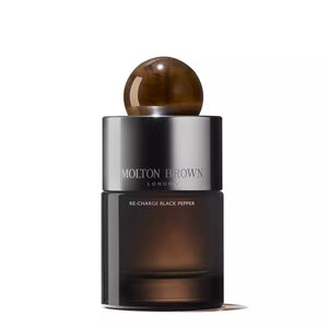 The MOLTON BROWN - RE-CHARGE BLACK PEPPER Eau de Parfum bottle is cylindrical and labeled with the brand's signature name. It features a glossy gradient from dark to light brown, topped with a spherical, marbled brown cap. This sleek and sophisticated design embodies the essence of dynamic sophistication.