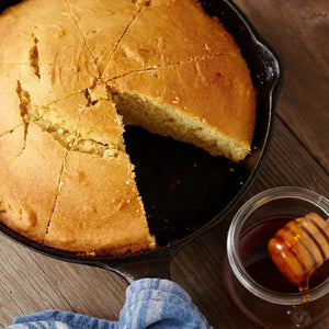 The bright yellow-orange bag, labeled "CUP4CUP GLUTEN FREE CORNBREAD," showcases an image of cornbread in a skillet with a slice cut out. This non-GMO mix, confirmed to be gluten free below the title, displays weight details: "Net Wt. 1lb (453.6g).